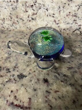 hand-blown art glass paperweight features a blue and sparkly sea turtle beach